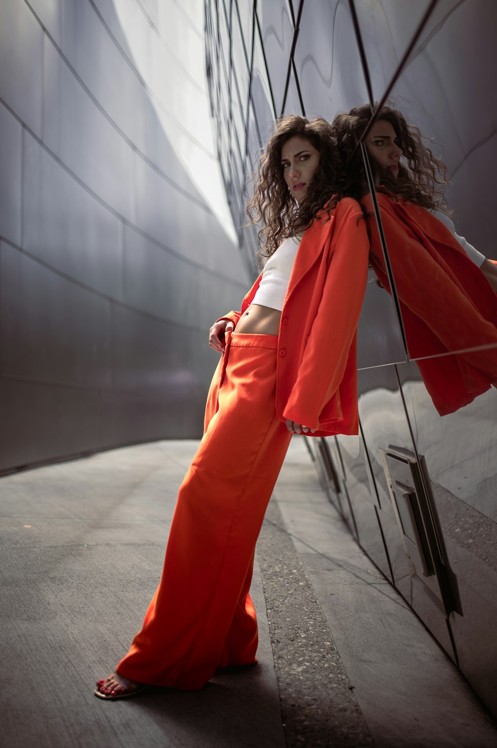 a woman in a red dress holding an umbrella