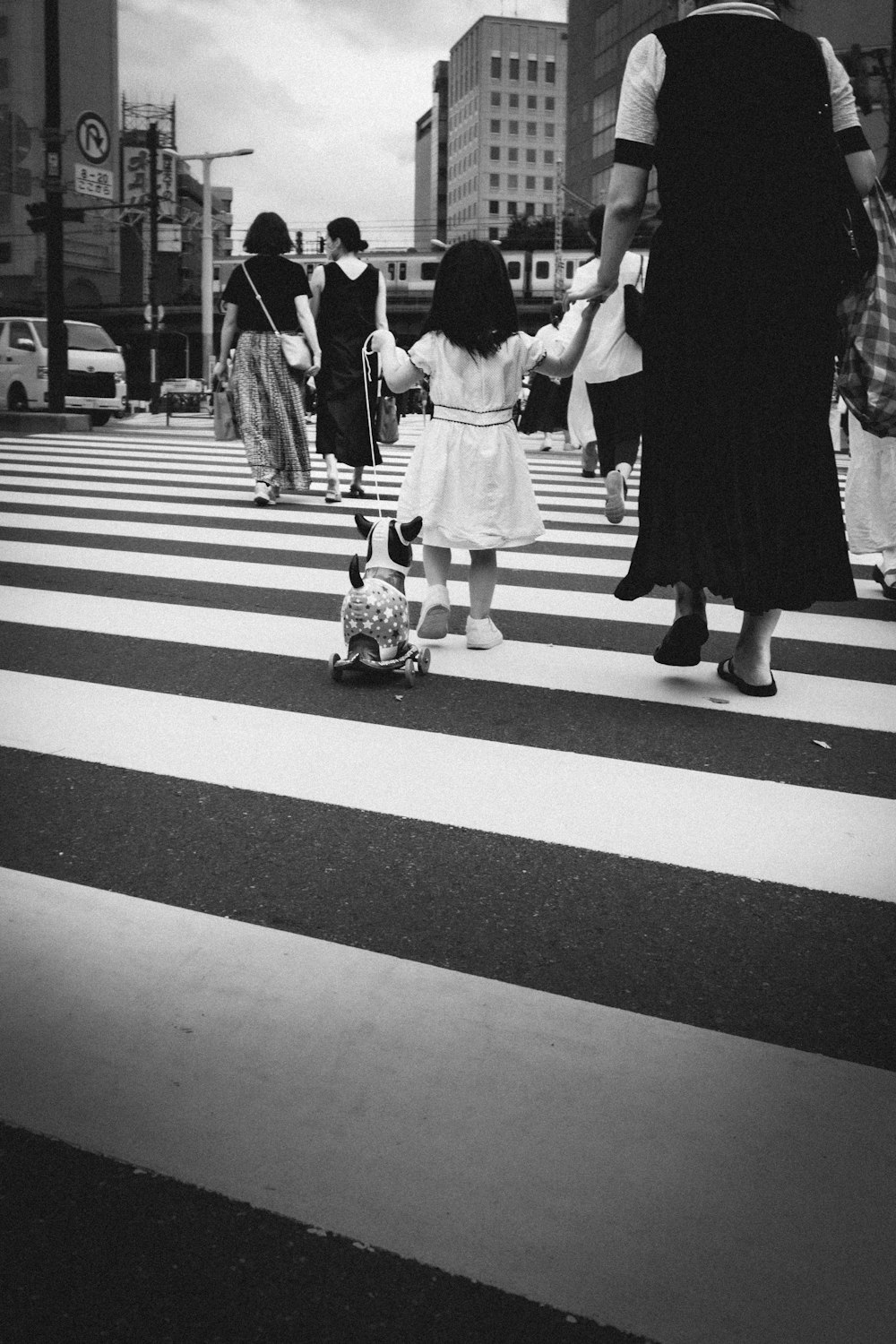 a little girl walking down the street