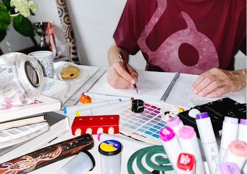 a person writing on a piece of paper