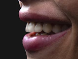 a person's mouth with teeth and tongue sticking out