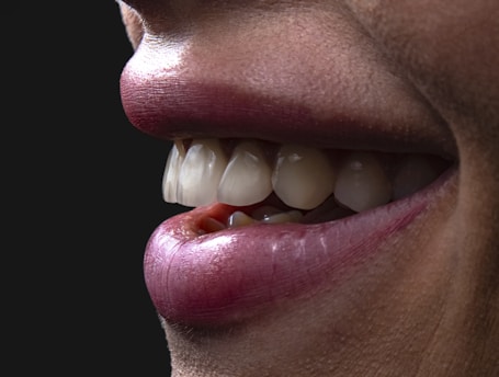 a person's mouth with teeth and tongue sticking out