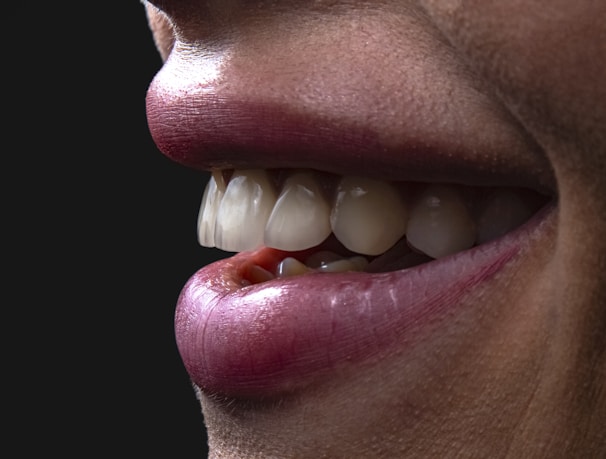 a person's mouth with teeth and tongue sticking out
