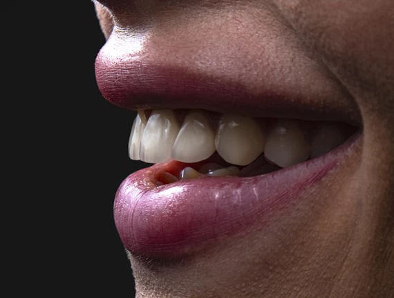 a person's mouth with teeth and tongue sticking out