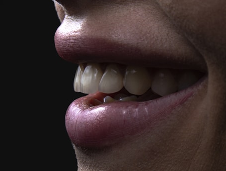 a person's mouth with teeth and a group of white balls