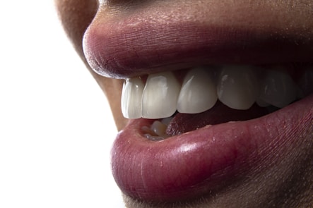 a close-up of a person's mouth with teeth showing