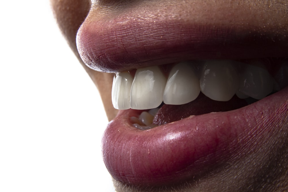 a close-up of a person's mouth with teeth showing