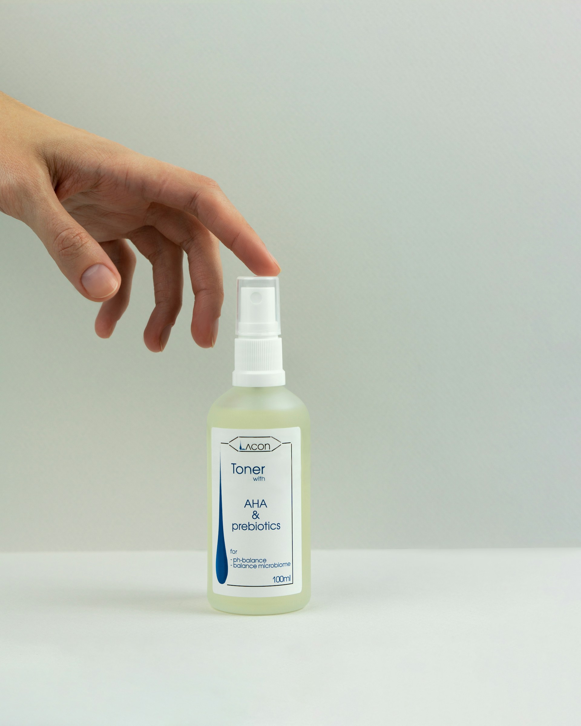 a hand holding a bottle of medicine