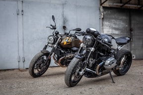motorcycles parked in front of a garage