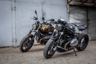 motorcycles parked in front of a garage
