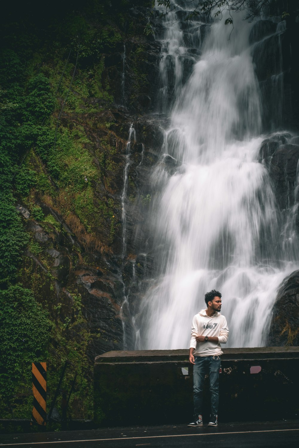 a person standing in front of a waterfall