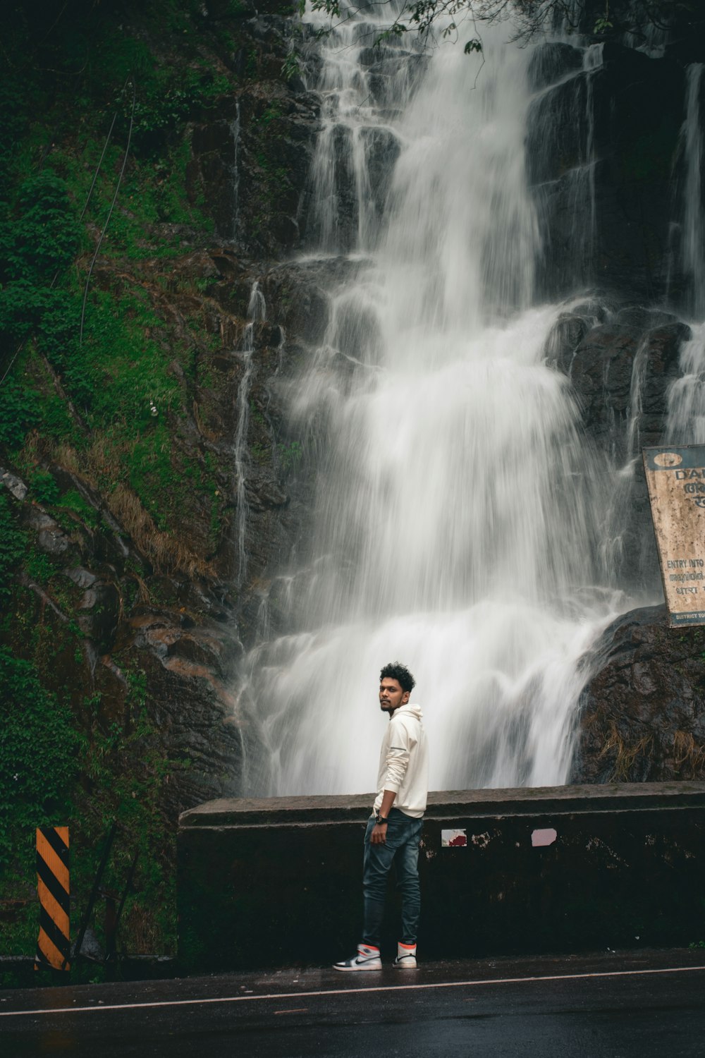 a person standing in front of a waterfall