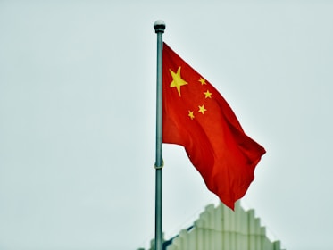 a red and yellow flag on a pole