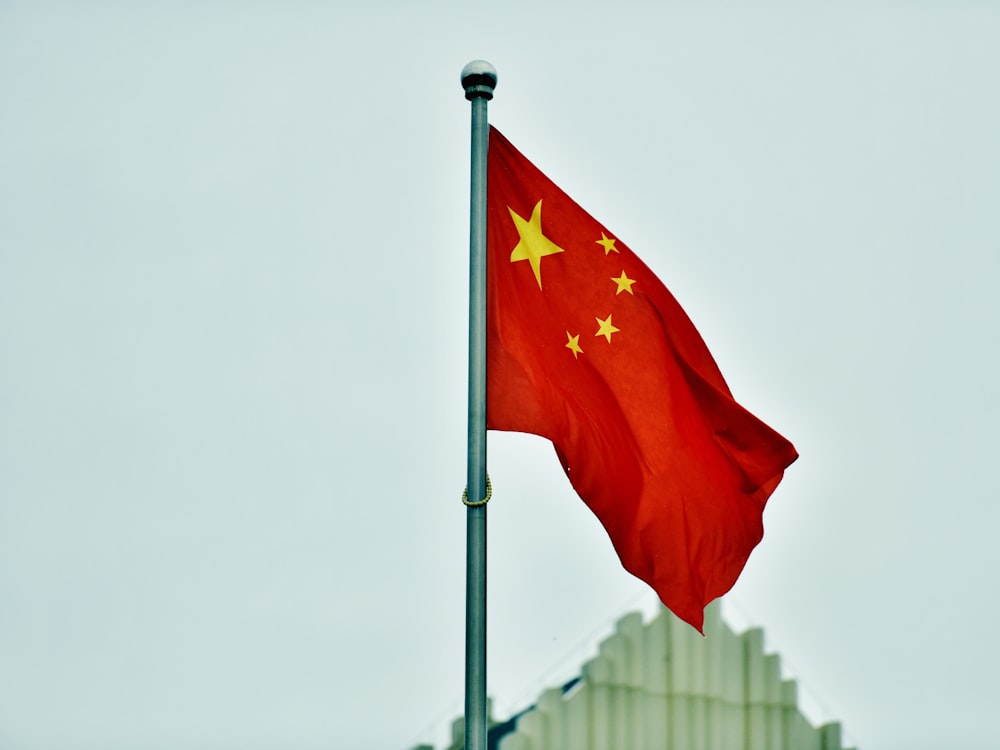 a red and yellow flag on a pole