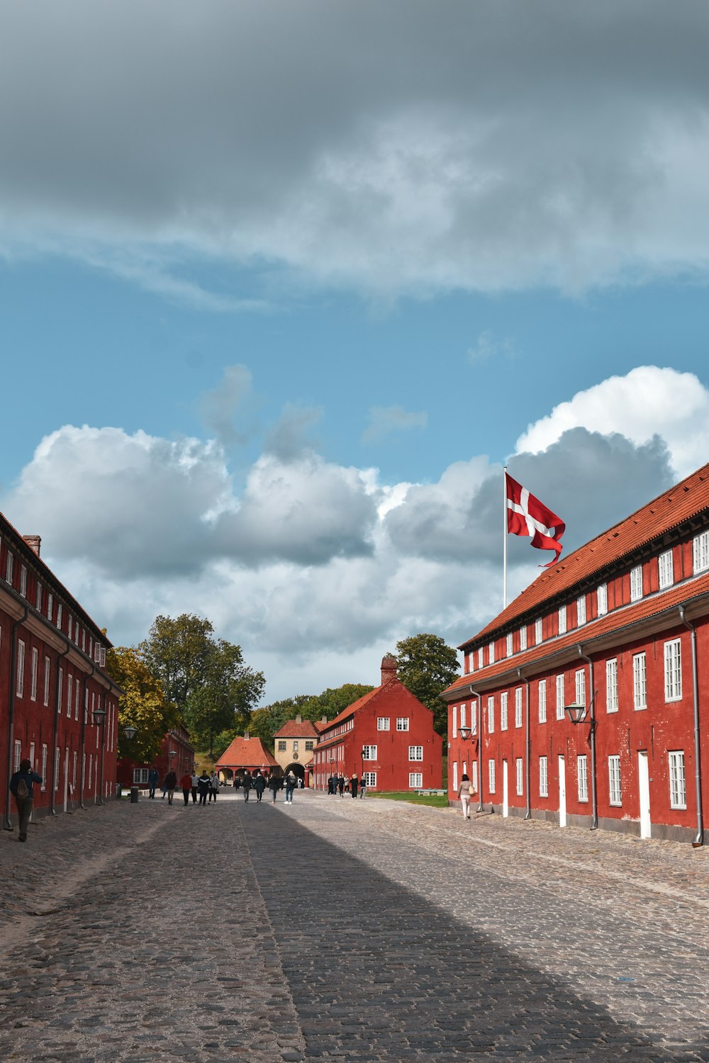 a brick road with buildings on either side of it