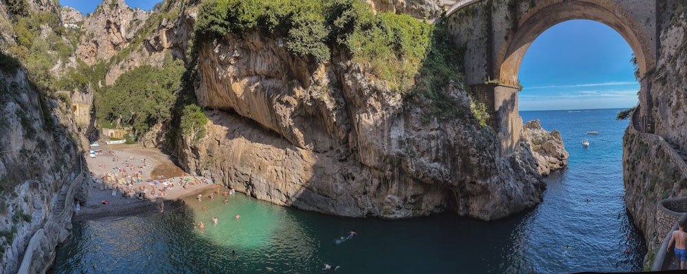 a large rock arch over a body of water