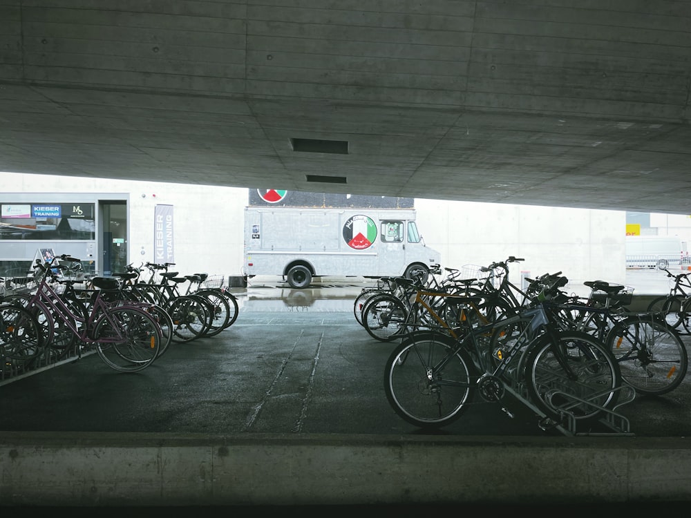 a group of bicycles parked in a parking garage