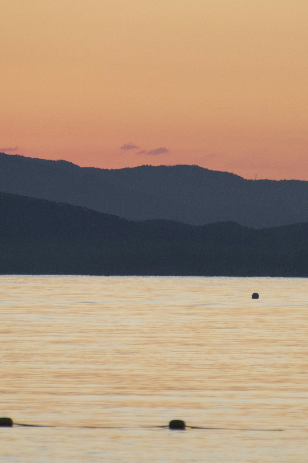 a body of water with mountains in the background