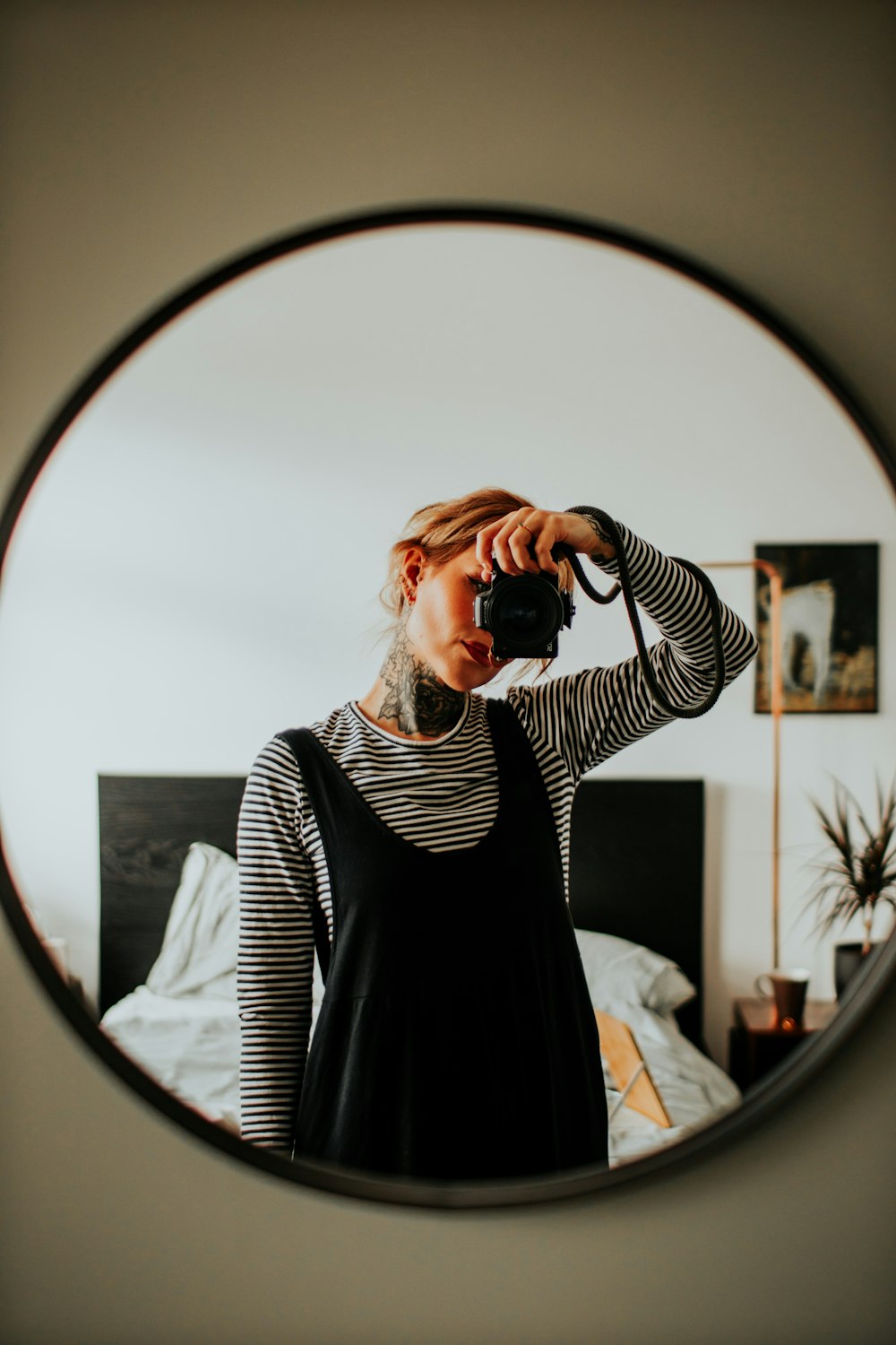 a person taking a picture of herself in a mirror