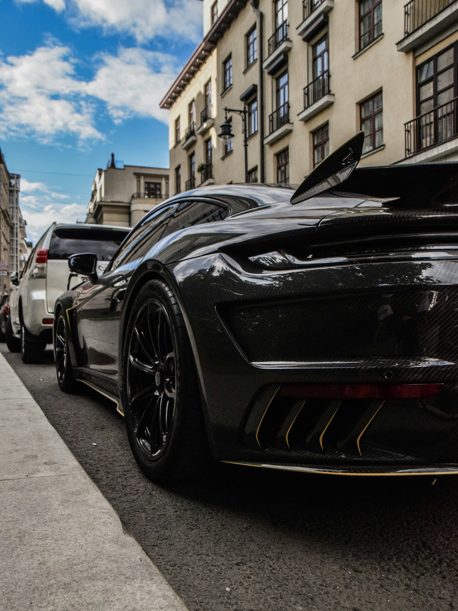 a black sports car parked on the side of a street