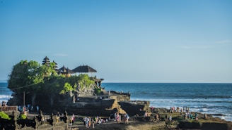 a beach with people and buildings