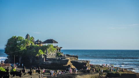 a beach with people and buildings