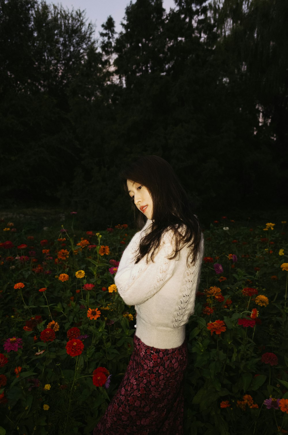 a person posing in a field of flowers