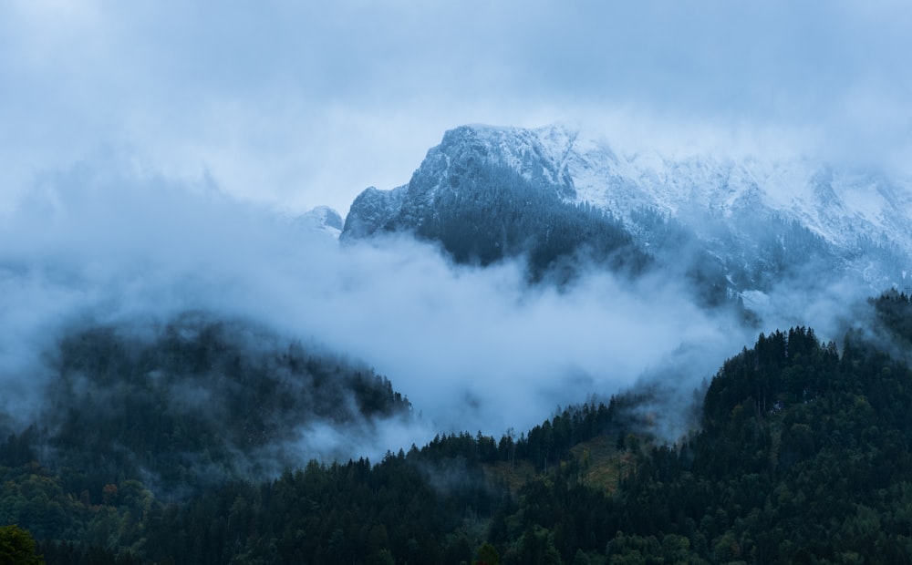 a mountain with clouds around it