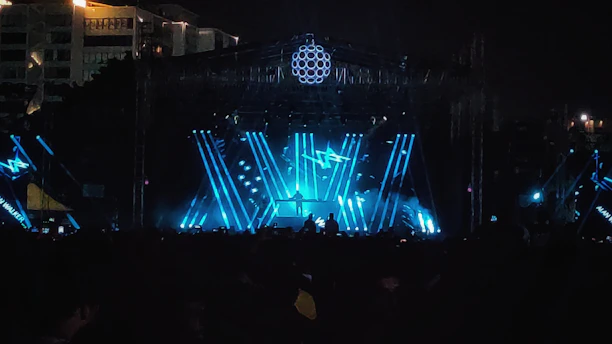 High-quality event stage with sturdy metal structure and dynamic lighting during an outdoor concert.