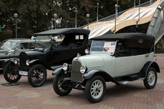 a row of cars parked on a brick road