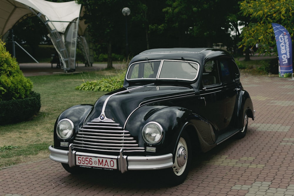 a black car parked on a brick road