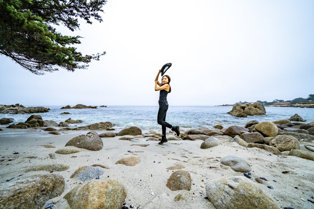 a man standing on a rocky beach