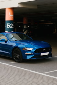a blue car parked in a parking lot