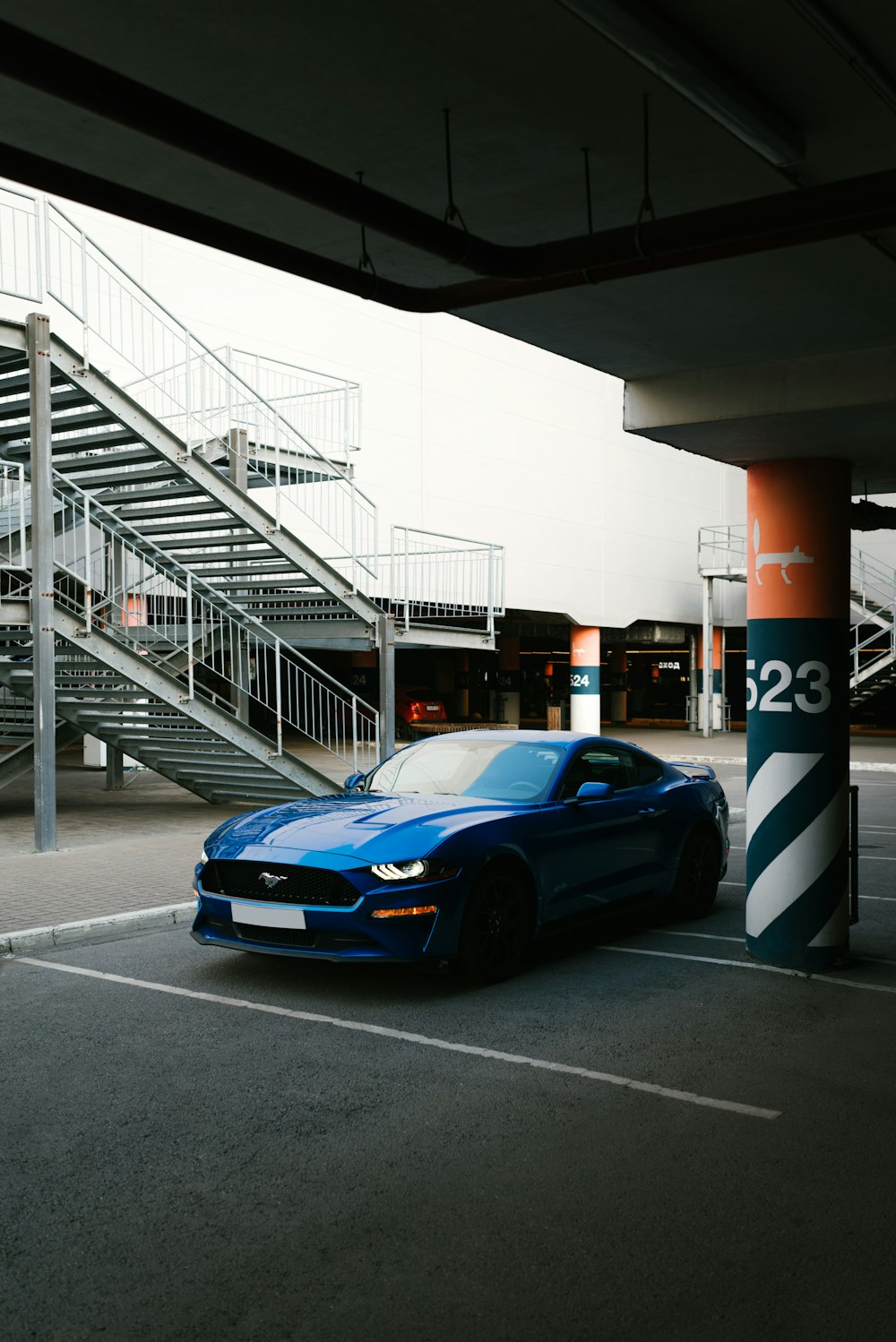 a blue sports car parked in a parking lot