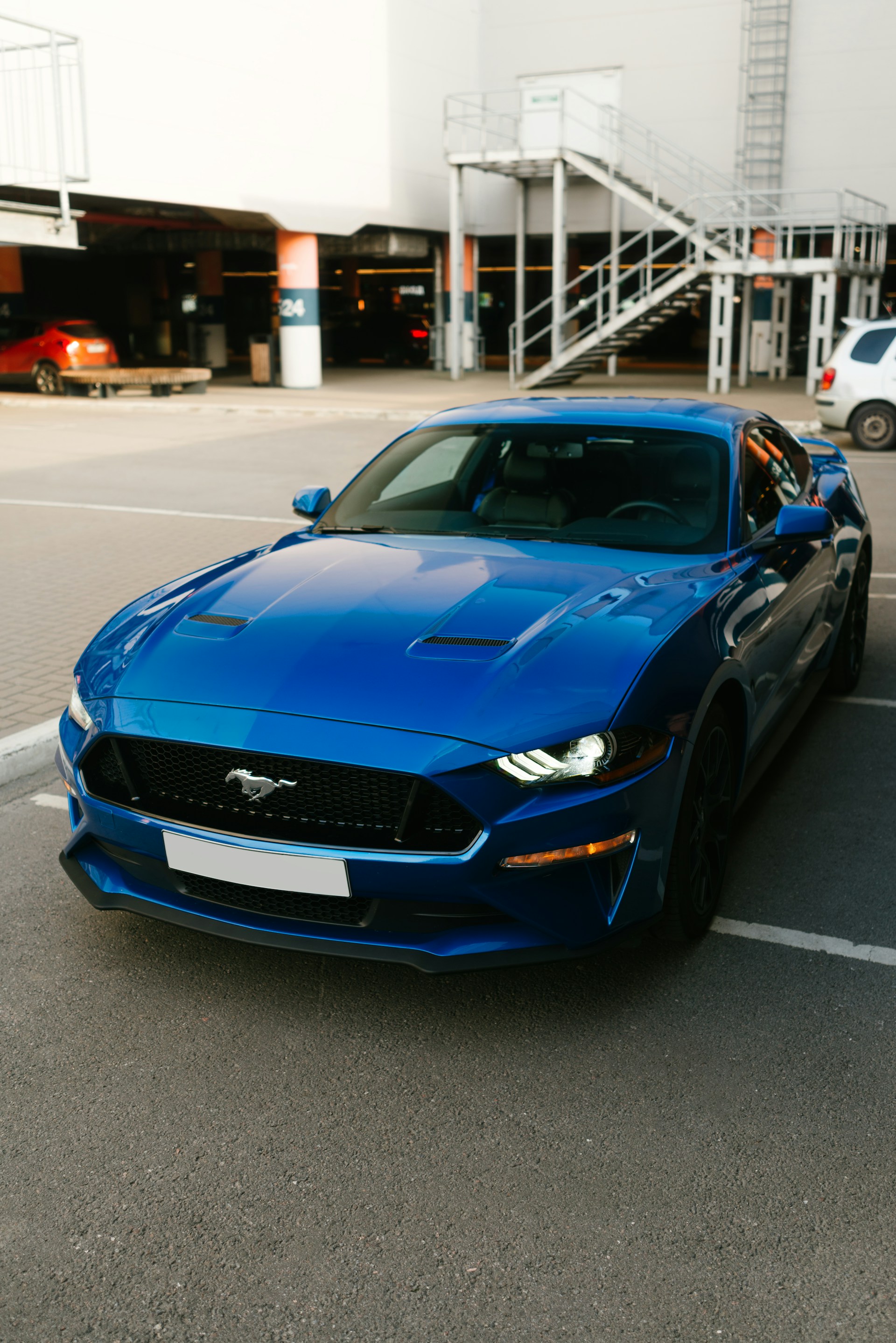 a blue sports car parked in a parking lot