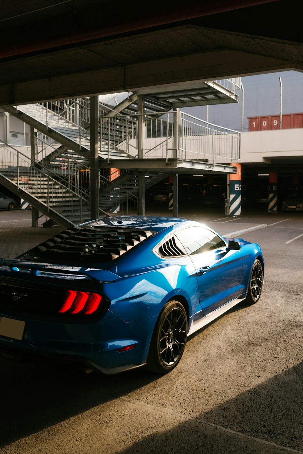 a blue sports car parked in a parking lot