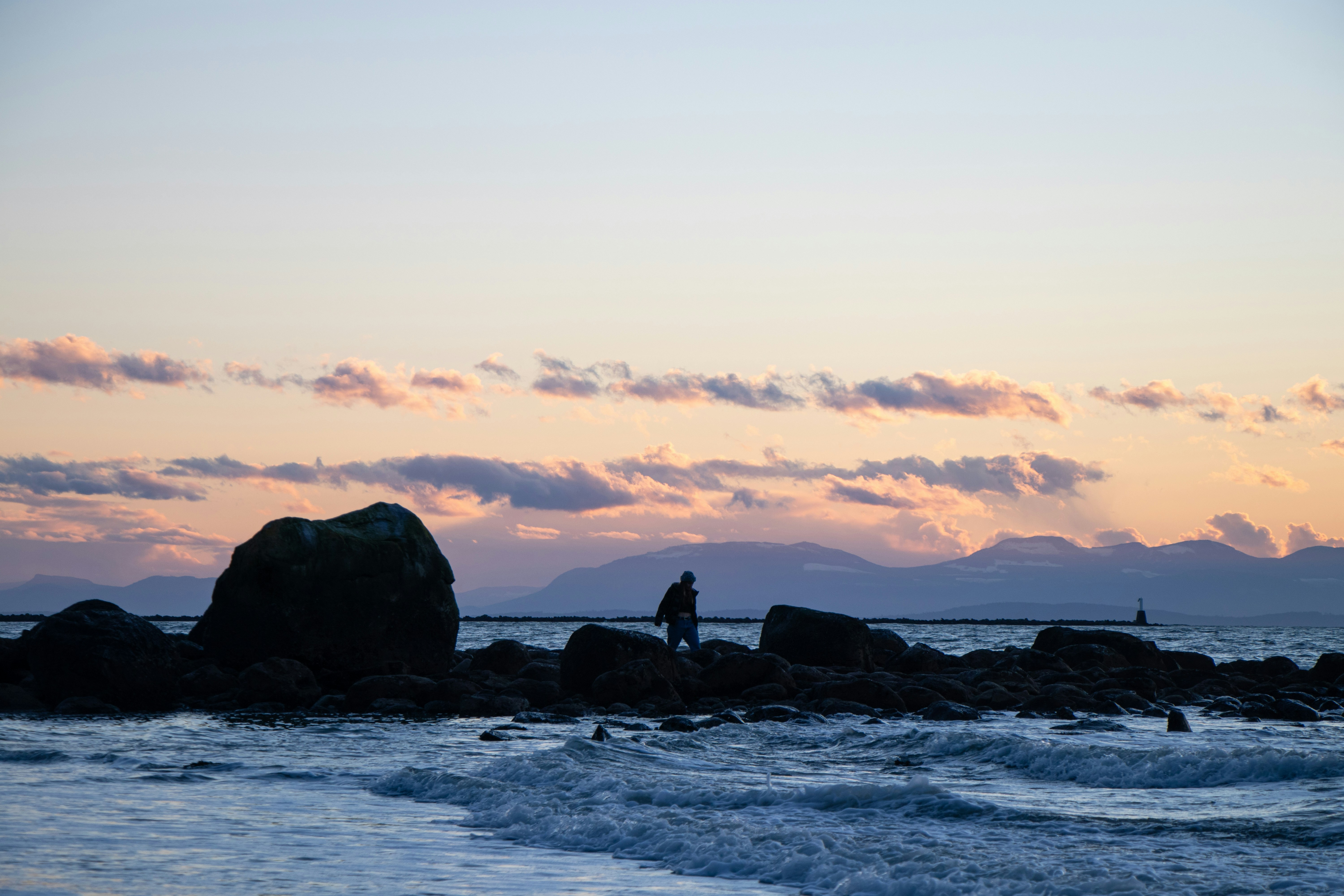 a person standing on a rock in the water