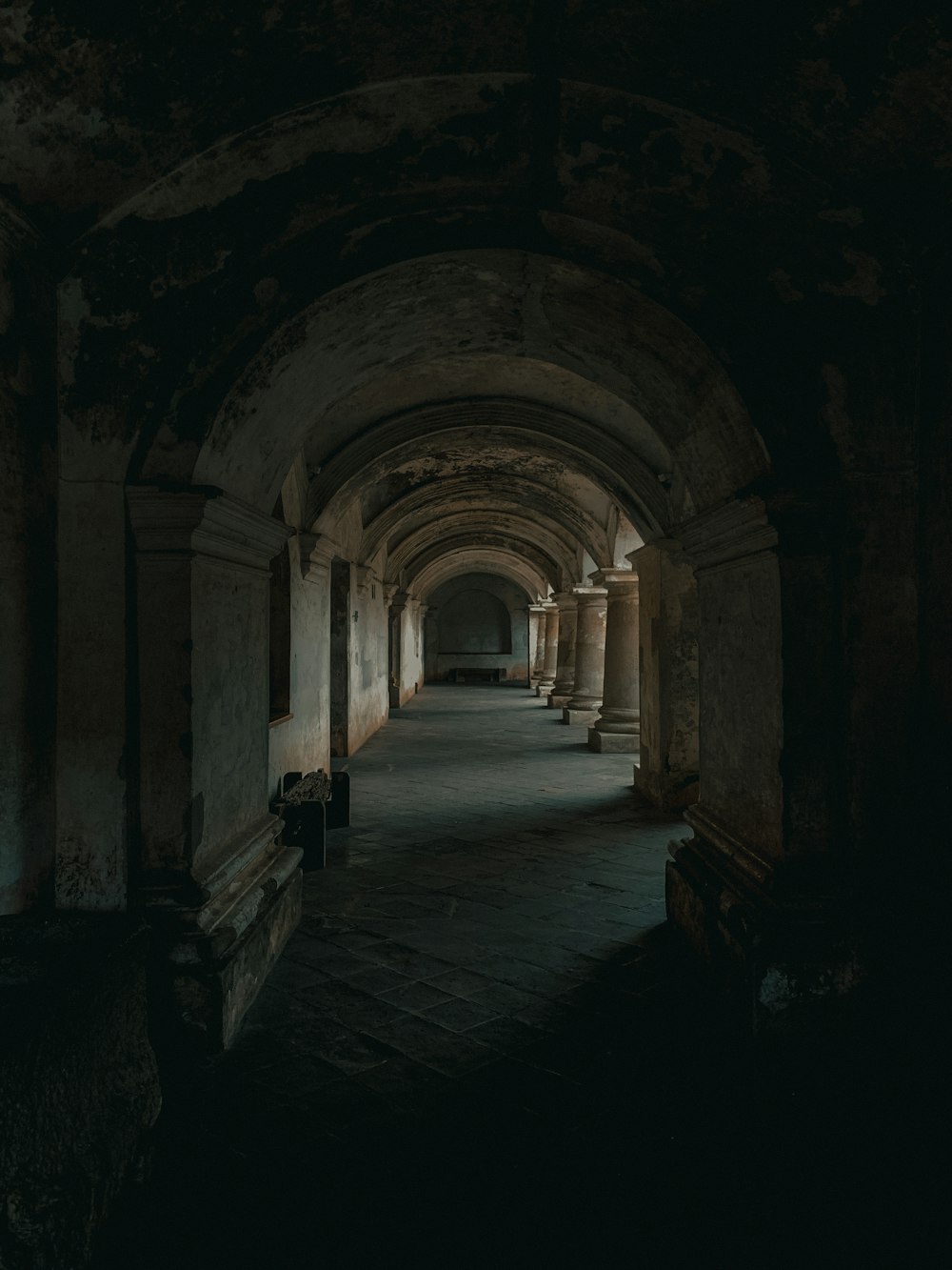 a stone hallway with columns