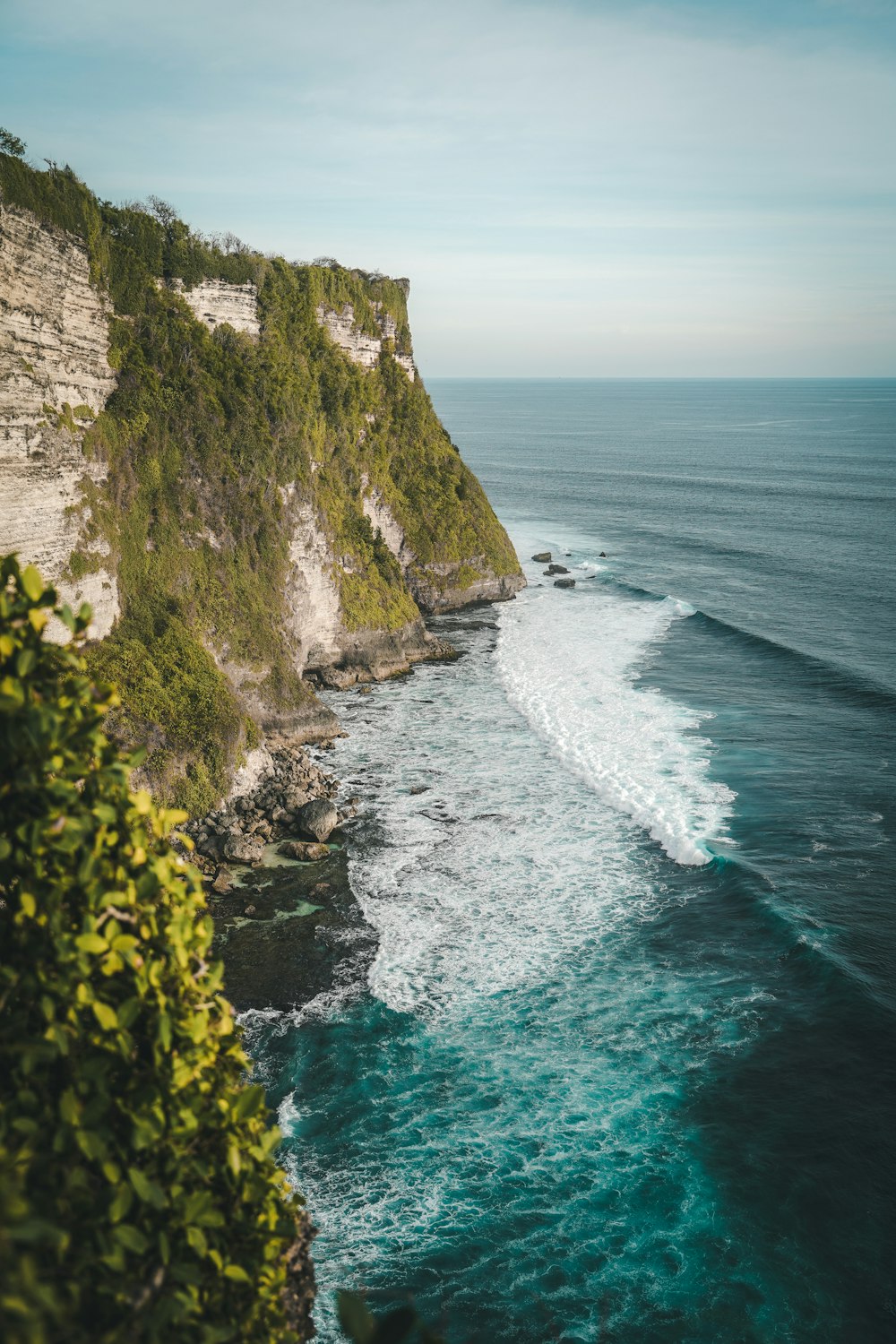 a cliff side with a body of water below