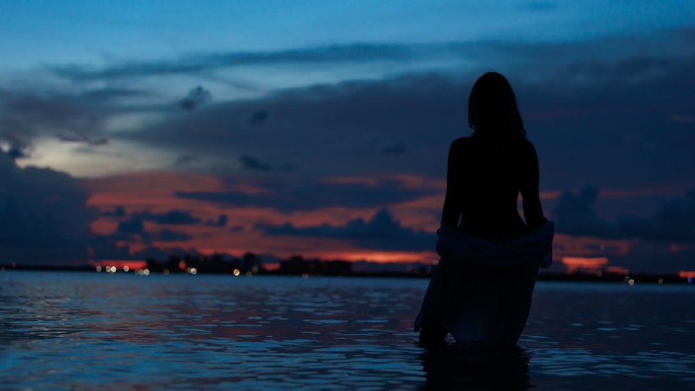 a person standing in front of a body of water