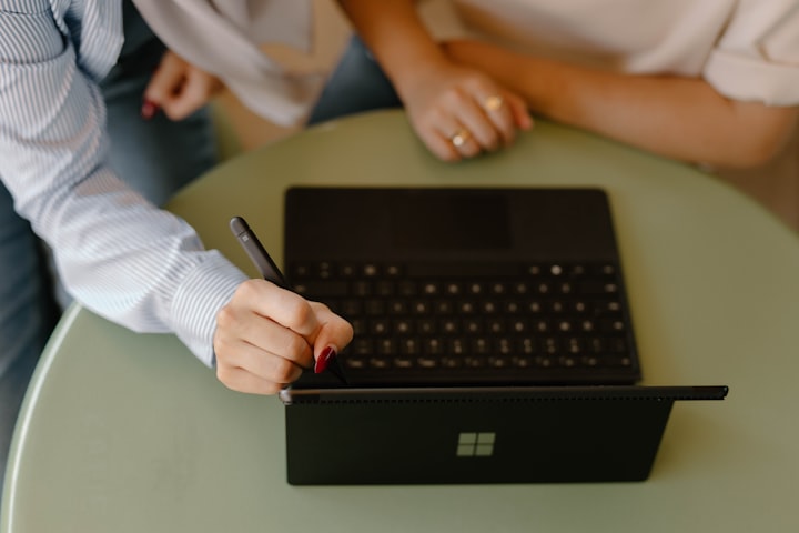 group over a laptop with digital pen