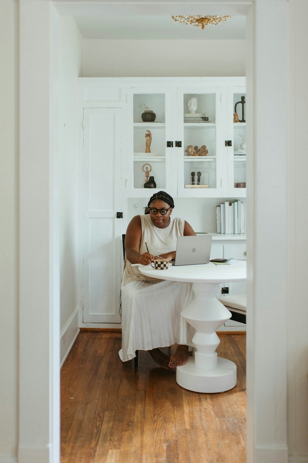 a person sitting at a desk with a laptop