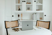 A cozy minimalist workspace with a laptop displaying the beautybevy website and a cup of tea.