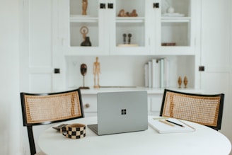 A cozy office workspace featuring a minimalist desk and laptop.