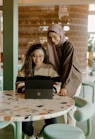 a woman and a girl looking at a laptop