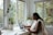 a woman sitting at a table with a laptop