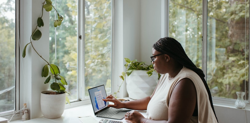 a woman sitting at a table with a laptop