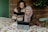 Two women sitting at a table with a laptop