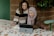 Two women sitting at a table with a laptop