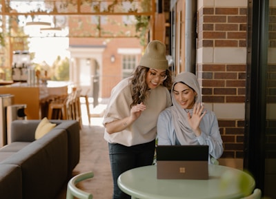 a woman sitting at a table using a laptop