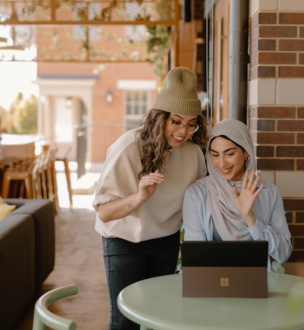 a woman sitting at a table using a laptop